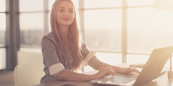 A content manager working on her computer, writing and editing content.